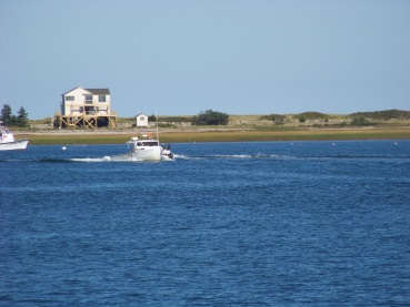 boat heading into plymouth harbor viewed from breakwater