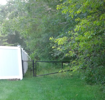 A gated entrance to an easement leading to misty meadow conservation A gated entrance to an easement leading to misty meadow conservation
