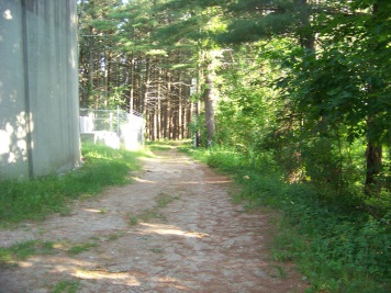 hiking trail past a water tower at myles standish monument reservation