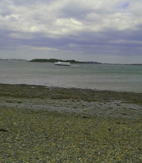 Ferry passes a stony beach at Webb Memorial State Park